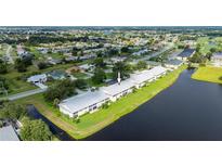 Aerial view of condo building near lake; desirable waterfront location at 1512 Rio De Janeiro Ave # 327, Punta Gorda, FL 33983