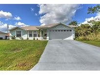 Charming light blue house with a two-car garage at 161 Coblentz St, Port Charlotte, FL 33954