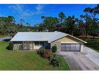 Single-story home with stone accents and a two-car garage at 617 Lomond Dr, Port Charlotte, FL 33953