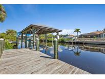 Spacious wooden dock with covered boat lift at 3494 Yukon Dr, Port Charlotte, FL 33948