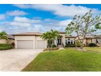 Beautiful two-car garage home with landscaping and a paved driveway at 24211 Savory Ln, Punta Gorda, FL 33955