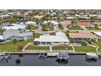 Aerial view of the property, showcasing its canal-front location and neighborhood at 950 Genoa Ct, Punta Gorda, FL 33950