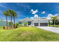 Single-Gathering home with two-car garage and palm trees at 9973 Calumet Blvd, Port Charlotte, FL 33981