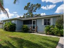 House exterior featuring a light blue color and landscaping at 860 Columbia St, Port Charlotte, FL 33948