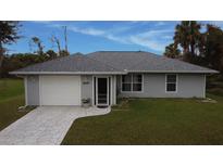 Exterior of a single-Gathering home with a paved driveway at 4471 Brickell Dr, North Port, FL 34286