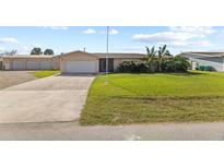 Single Gathering home with attached garage and landscaping at 543 Lincoln Nw Ave, Port Charlotte, FL 33952