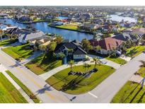 Luxury waterfront home with circular driveway and canal access at 590 Toulouse Dr, Punta Gorda, FL 33950