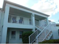 Two-story building with a balcony and stairs at 5725 Greenwood Ave # 4, North Port, FL 34287