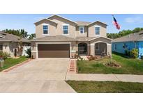 Two-story house with brown garage door and American flag at 10122 Winding River Rd, Punta Gorda, FL 33950