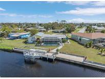 Aerial view of canal-front home with private dock and pool at 111 Dunn Ne Dr, Port Charlotte, FL 33952