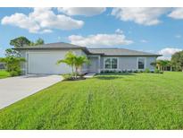 Newly built home with a one-car garage and manicured lawn at 11145 2Nd Ave, Punta Gorda, FL 33955