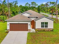 Charming single-story home featuring a two-car garage, landscaped front yard, and neutral color palette in a vibrant neighborhood at 1293 Preston St, Port Charlotte, FL 33952