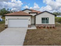 Newly constructed one-story home with a two-car garage at 1415 Nackman Rd, North Port, FL 34288