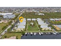 Stunning aerial view of the condo community with manicured lawns, boat docks, and a sparkling pool for relaxing and enjoying at 2000 Bal Harbor Blvd # 321, Punta Gorda, FL 33950