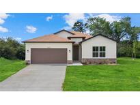 Charming single-story home featuring a two-car garage, well-manicured lawn, and inviting front entrance at 4637 Irdell Ter, North Port, FL 34288