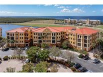 Aerial view of a luxurious condo building with water views at 95 Vivante Blvd # 9534, Punta Gorda, FL 33950