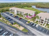 Condo building with ample parking and surrounding landscape at 175 Kings Hwy # 718, Punta Gorda, FL 33983