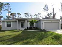 Single-story home with gray siding and lawn at 13387 Drysdale Ave, Port Charlotte, FL 33981