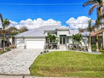 Stunning curb appeal: single Gathering home with a metal roof and paved driveway at 1450 Kiwi Ct, Punta Gorda, FL 33950