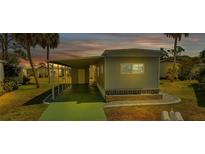 Mobile home with covered carport and landscaped walkway at 6450 Floral Ct, North Port, FL 34287