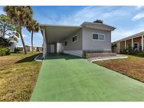 Charming home featuring a carport and well-maintained landscaping at 6450 Floral Ct, North Port, FL 34287
