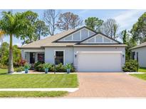 Modern one-story home with brick paver driveway at 15257 Mille Fiore Blvd, Port Charlotte, FL 33953
