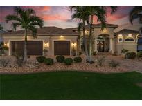 Stunning two-story home with three-car garage and beautiful landscaping at 238 Lido Dr, Punta Gorda, FL 33950
