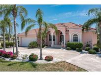 Charming two-story home with a terracotta roof and lush landscaping at 2507 Via Veneto Dr, Punta Gorda, FL 33950