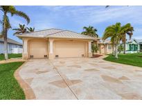 Tan two-story house with a two-car garage and landscaped yard at 15460 Longview Rd, Port Charlotte, FL 33981