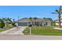 Single-Gathering home with driveway and landscaping at 167 Mocha Ct, Punta Gorda, FL 33983