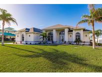 Single Gathering home with a manicured lawn and palm trees at 17183 Ohara Dr, Port Charlotte, FL 33948