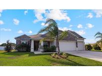 Single-Gathering home with stone facade and two-car garage at 2705 Lamkin Rd, North Port, FL 34288