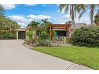 A charming house with a pergola and lush landscaping at 4290 Randypaar St, Port Charlotte, FL 33948