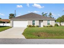 One-story home with a spacious yard and attached garage at 820 Haleybury St, Port Charlotte, FL 33948