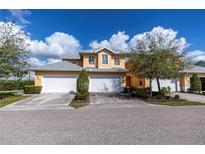 Tan two car garage with landscaping at 25623 Heritage Lake Blvd. # 57, Punta Gorda, FL 33983