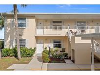 Two-story condo building with landscaped grounds and walkway at 1512 Rio De Janeiro Ave # 111, Punta Gorda, FL 33983