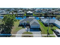 Aerial view of a single-Gathering home with a paver driveway and canal access at 21341 Edgewater Dr, Port Charlotte, FL 33952