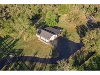 Aerial view of a ranch-style home with a large yard and detached garage at 1010 Robinhood Dr, Punta Gorda, FL 33982