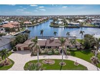 Aerial view of waterfront home with pool and landscaped grounds at 1925 Jamaica Way, Punta Gorda, FL 33950