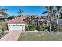 Single-story home with tile roof, attached garage, and landscaped yard at 24282 Silver Ln, Punta Gorda, FL 33955