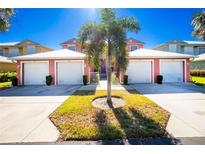 Three-unit building with attached garages, palm trees, and well-maintained landscaping at 2002 Bal Harbor Boulevard # 811, Punta Gorda, FL 33950