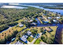 A scenic aerial view of a waterfront property surrounded by lush greenery and waterways at 28427 Sabal Palm Dr, Punta Gorda, FL 33982