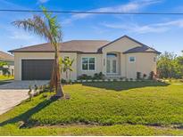 A charming one-story home with a brown garage door and a manicured lawn at 8306 Santa Cruz Dr, Port Charlotte, FL 33981