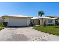 Single-story home exterior with attached garage and mature landscaping at 2501 Rio Largo Ct, Punta Gorda, FL 33950