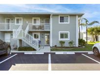 Front view of condo building with parking and landscaping at 3310 Loveland Blvd # 2304, Punta Gorda, FL 33980