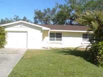 Ranch-style home with a one-car garage and well-maintained lawn at 850 Cordele Nw Ave, Port Charlotte, FL 33948