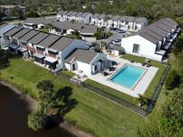 Aerial view of community with pool, showing building exteriors and landscaping at 2000 Forrest Nelson Blvd # C8, Port Charlotte, FL 33952