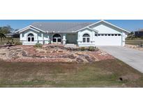 Single-story home with landscaped yard and attached garage at 25380 Vantage Ln, Punta Gorda, FL 33983