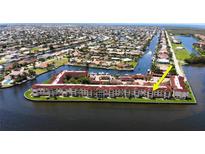 Aerial view of waterfront condo community, highlighting building location and surrounding waterways at 1 Colony Point Dr # 16C, Punta Gorda, FL 33950