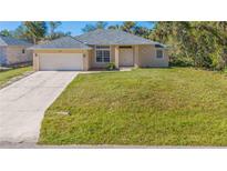Newly constructed single-story home with attached garage and large yard at 267 Lecturn St, Port Charlotte, FL 33954